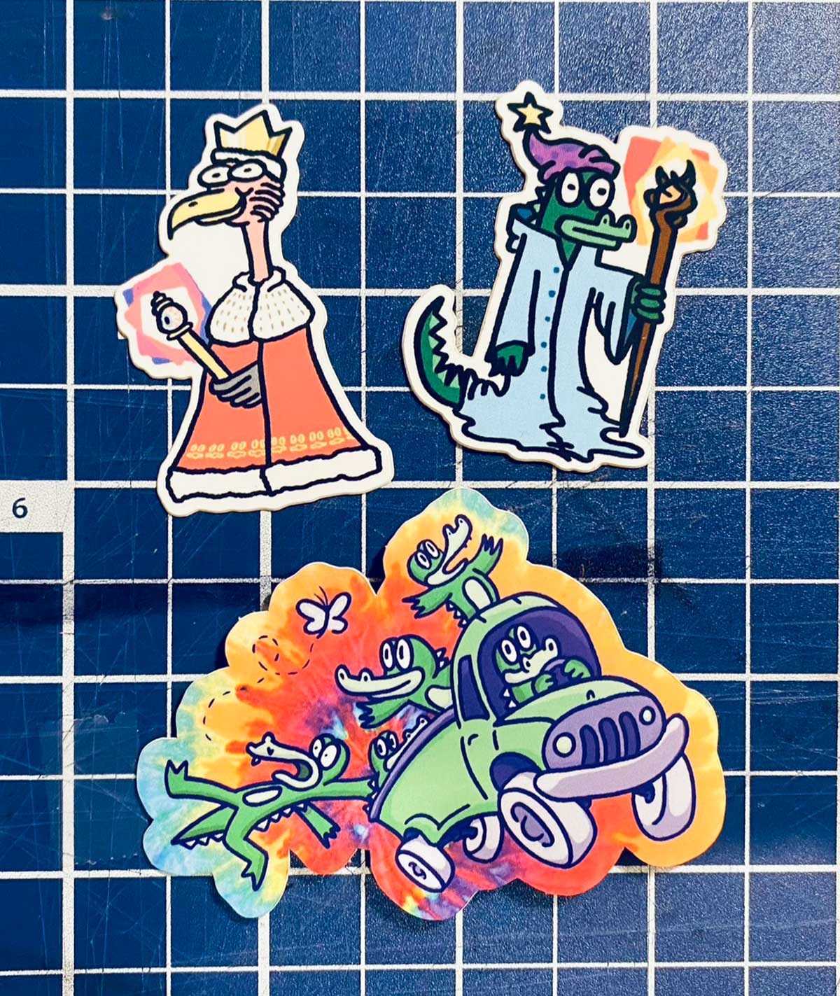 Three stickers, left to right, up to down: King Gizzard, Lizard Wizard, and a band of alligators on a truck.